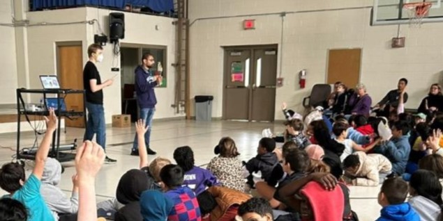 Sam Brandsen and Raghav Swaminathan speak to elementary school students