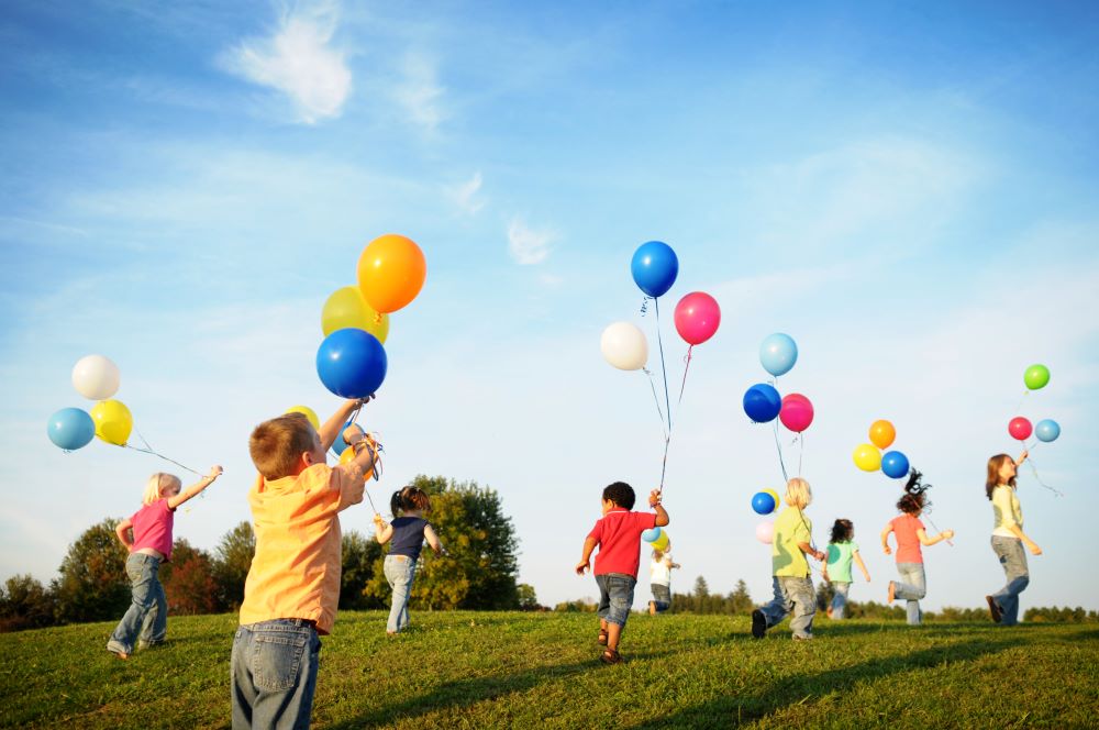 children outside with balloons