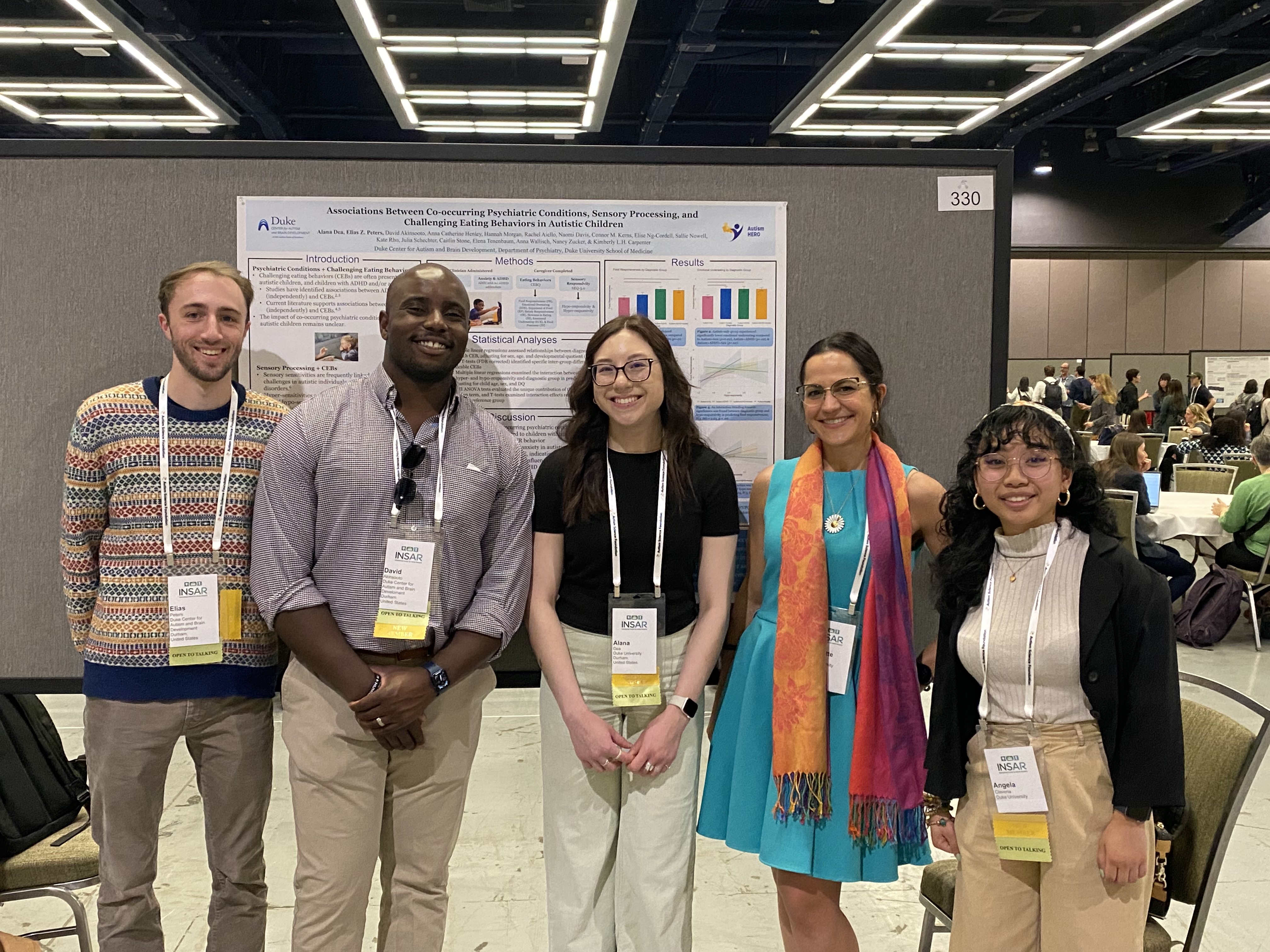 COMET study team members with a research poster