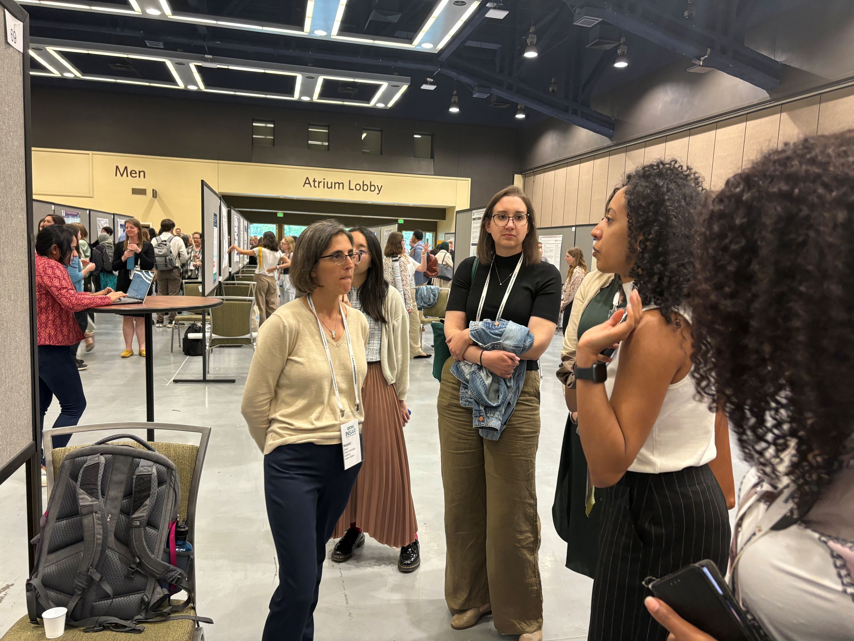 Naomi Davis speaks to INSAR conference attendees in the poster hall
