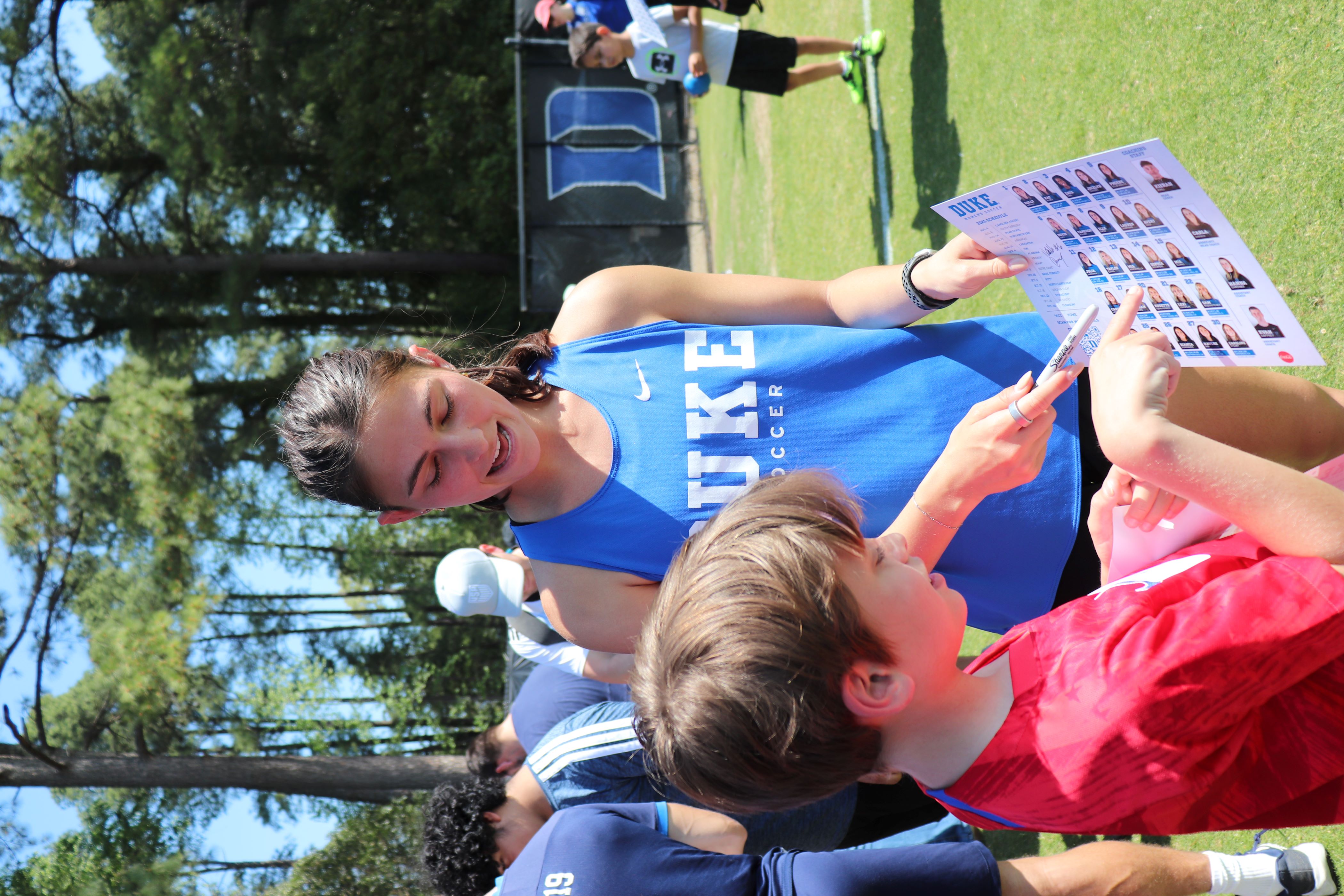 Duke player Mia signs an autograph