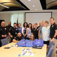 Group of people with police officers in conference room