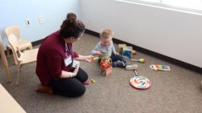 adult playing with infant