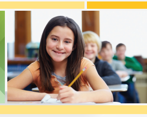 Child at desk holding pencil