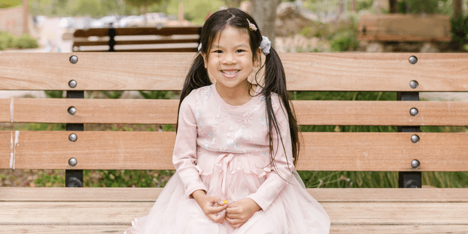 stock photo of girl on park bench