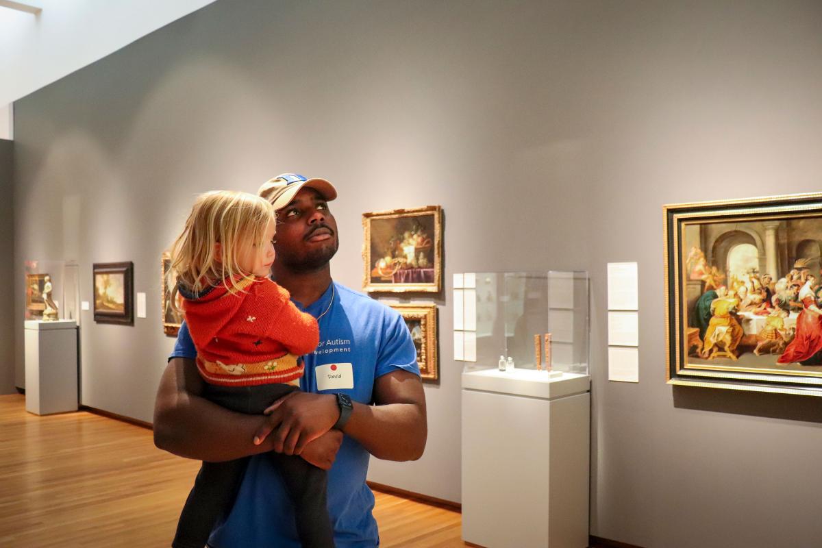 David Akinsooto carrying a child