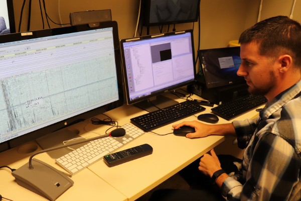 man reading data on a computer in a research lab