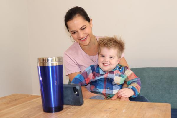 Adult with a child looking at a mobile device