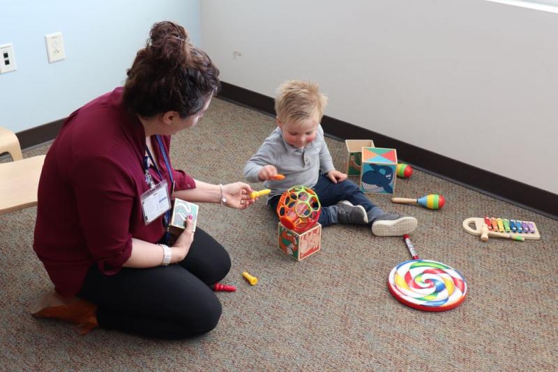 adult playing with toddler