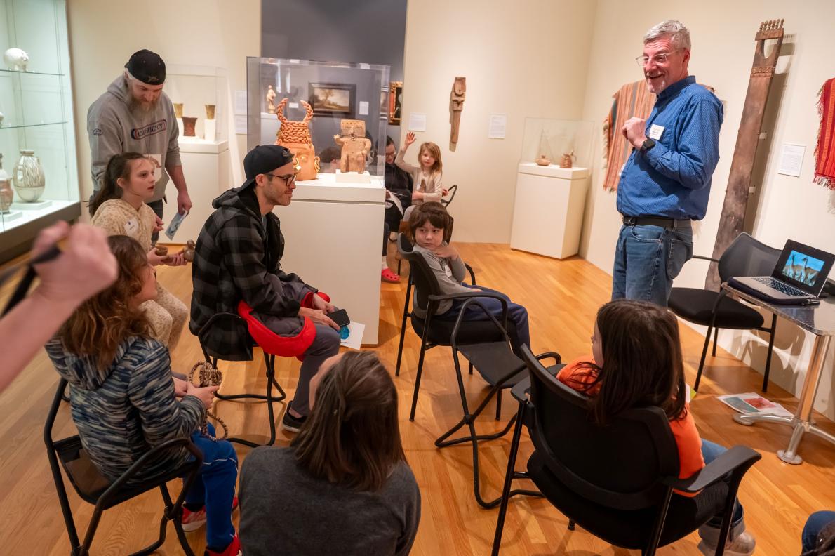 tour guide speaks to a group in a gallery