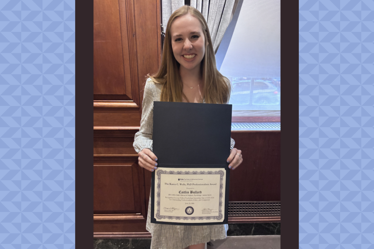 Caitlin Bullard, PhD, holding a certificate for the professionalism award