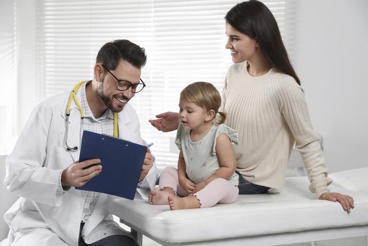 Mother and her cute baby having appointment with pediatrician in clinic