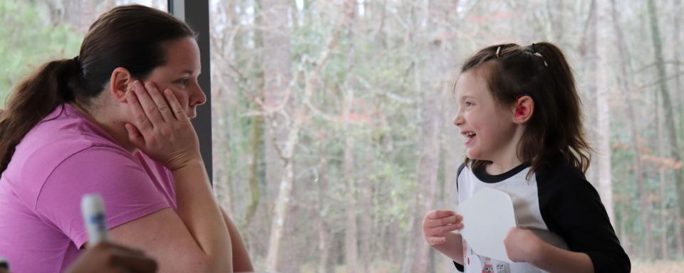 adult and child smile at each other