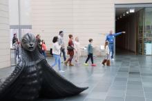 group walks through an art gallery with a guide