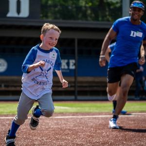 child running on baseball field