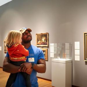 David Akinsooto carrying a child