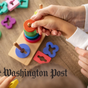 hands of a child and adult holding a ring toy together