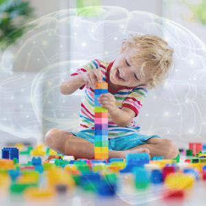 Child playing with blocks. Overlay of a brain with illuminated EEG points in the background.